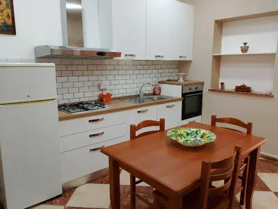 a kitchen with a wooden table with a bowl on it at Franci Zisa House in Palermo