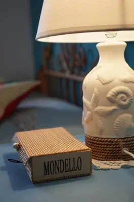 a lamp and a box on a table next to a candle at Orizzonte d'acqua Palermo in Palermo