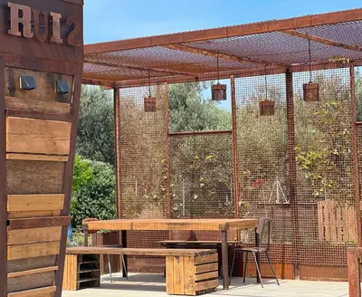 a patio with a table and a bird cage at Rui2 Exclusive Accomodation in Terrasini