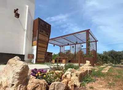 a building with a sign that reads rtd next to some rocks at Rui2 Exclusive Accomodation in Terrasini