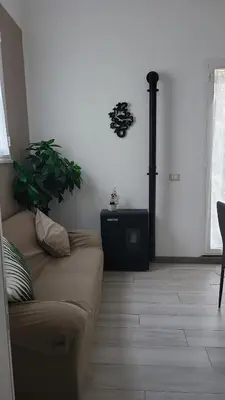 a living room with a couch and a fireplace at La loggia Apartment in Palermo