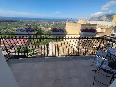 a balcony with chairs and a view of a city at Asia Sicilian Home in Carini
