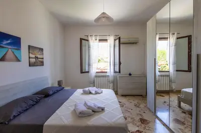 a bedroom with a large bed with towels on it at Casa Cloe Mondello in Palermo