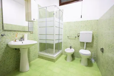 a bathroom with a sink and a toilet and a shower at Casa Cloe Mondello in Palermo