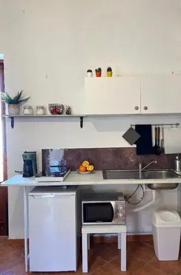 a kitchen with a sink and a microwave at Casamori 3- nel cuore del mercato Ballarò in Palermo