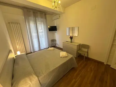 a bedroom with a bed and a dresser and a window at La Casa di Baloo in Palermo
