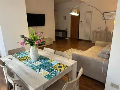 a living room with a table with a vase of flowers on it at La Casa di Baloo in Palermo