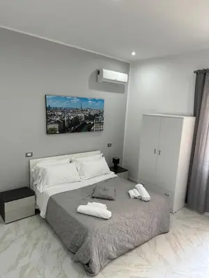 a bedroom with a bed with two towels on it at Agadir Apartment in Palermo