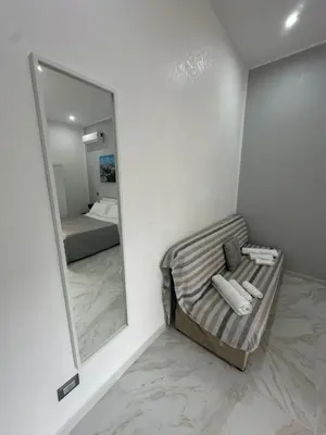 a mirror in the corner of a room with a bed at Agadir Apartment in Palermo