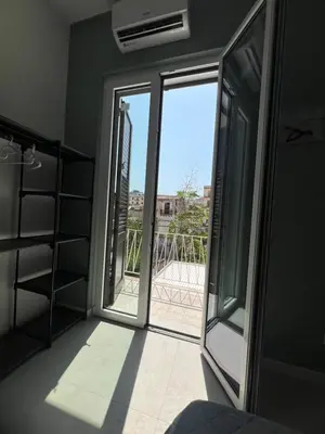 a room with a sliding glass door with a balcony at Al Tribunale Guest House in Palermo