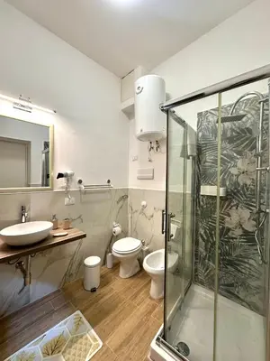 a bathroom with a shower and a toilet and a sink at Shama APARTMENTS in Palermo