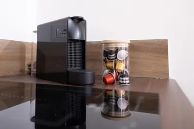 a microwave and a coffee maker on a table at Gravina 75 Rooms in Palermo