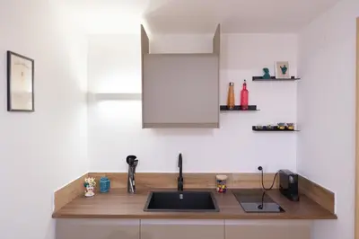 a kitchen with a sink and a counter top at Gravina 75 Rooms in Palermo