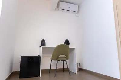 a chair sitting at a desk in a room at Gravina 75 Rooms in Palermo