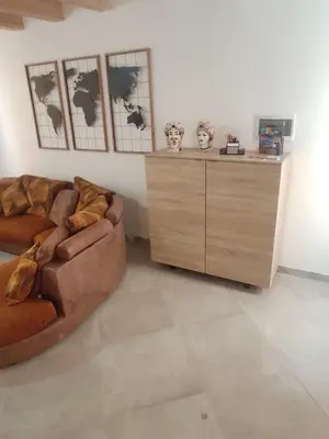 a living room with a couch and a cabinet at Central modern vacation home in Lascari - Casa Vacanze Luna in Lascari