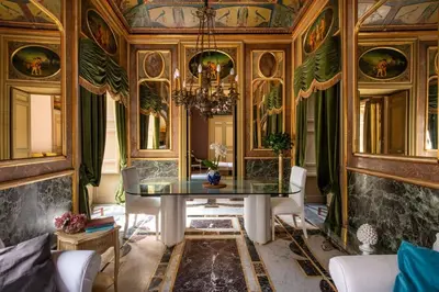 a dining room with a table and a chandelier at iFlat Suite del Barone with Terrace in Palermo