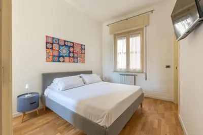 a bedroom with a large white bed and a window at Vetro Apartments by Wonderful Italy in Palermo