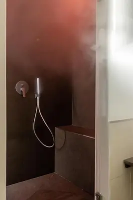 a shower in a bathroom with a hose at Vetro Apartments by Wonderful Italy in Palermo
