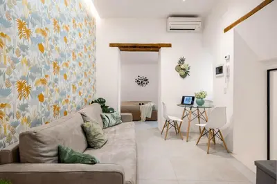 a living room with a couch and a table at Vittorio Maison - centro storico in Palermo