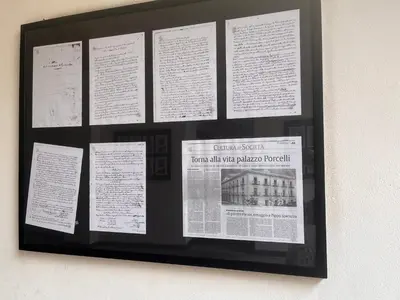 a display of papers on a wall at La Loggia del Capo in Palermo