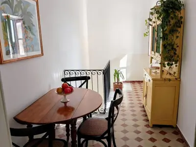 a table and chairs with a bowl of fruit on it at Rooftop Magione in Palermo