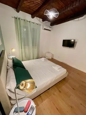 a bedroom with a bed and a television in it at Vicolo Morici in Palermo