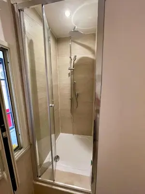 a shower with a glass door in a bathroom at Vicolo Morici in Palermo