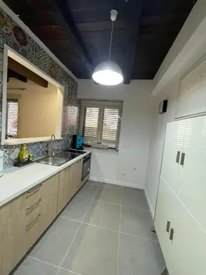 a large kitchen with a sink and a mirror at Vicolo Morici in Palermo