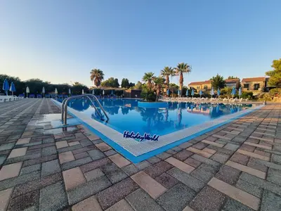 a swimming pool at a resort with a slide at Respiro di Mare by Holiday World in Buonfornello