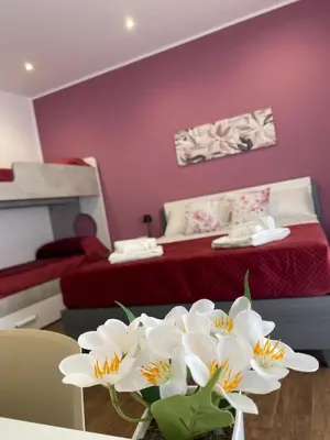 a bedroom with a bed and a table with white flowers at Palermo Flowers Suites in Palermo