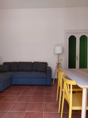 a living room with a couch and a table and chairs at Volturno 50 in Palermo