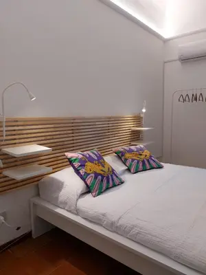 a bedroom with a bed with two pillows on it at Volturno 50 in Palermo