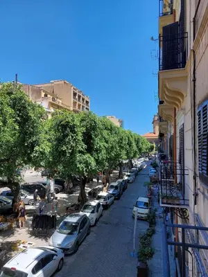 a street with cars parked on the side of a building at Volturno 50 in Palermo