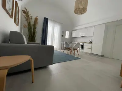 a living room with a couch and a table at Anfrasipe apartment in Terrasini