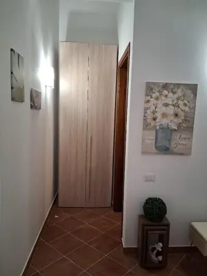a room with two chairs and a table with a swing at Raggio di Sole in Campofelice di Roccella