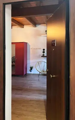 an open door into a room with a chair at Malfitano View in Palermo