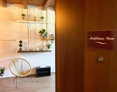 a room with a chair and a sign on the door at Malfitano View in Palermo
