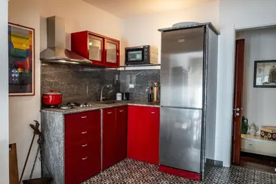 a kitchen with red cabinets and a stainless steel refrigerator at Habitat in Palermo