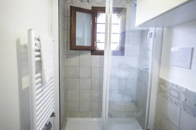 a shower with a glass door in a bathroom at B&B del Massimo in Palermo