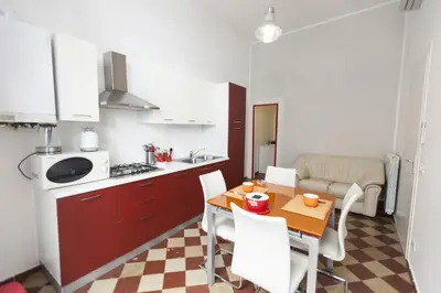 a kitchen and dining room with a table and chairs at B&B del Massimo in Palermo