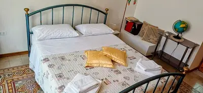 a bed with two pillows on it in a bedroom at Casa del Vecchio Borgo in Caccamo