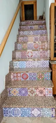 a set of stairs with colorful tiles on them at Casa del Vecchio Borgo in Caccamo