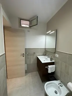 a bathroom with a sink and a mirror at A Little Modern House in Palermo