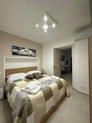 a bedroom with a large bed with towels on it at A Little Modern House in Palermo