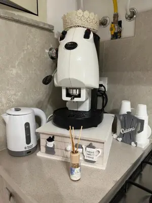 a white coffee maker sitting on a counter at A Little Modern House in Palermo