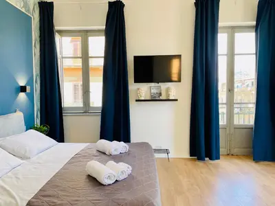 a bedroom with a bed with rolled towels on it at La casa di Didì in Palermo