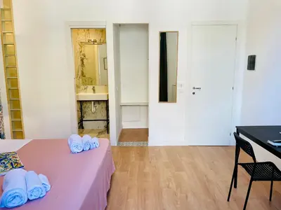 a room with a pink bed with towels on it at La casa di Didì in Palermo