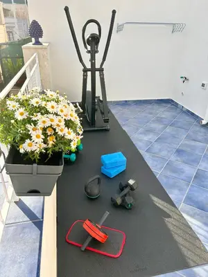 a table with a camera and flowers on it at Borgo la Madrice in Castellammare del Golfo