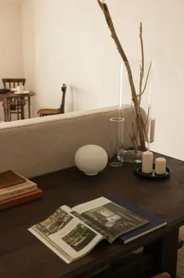 a table with a magazine and a vase on it at Almarìa - Le case del Castello - San Nicola L'Arena - Trabia in Trabia