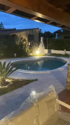 a swimming pool in a backyard at night at Villetta SCHIRÒ - BAGNASCO in Campofelice di Roccella